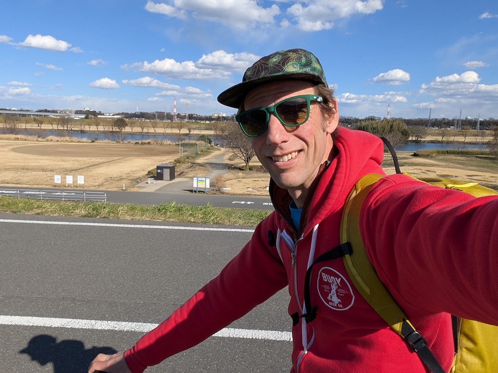 Mike riding an ebike along the Edo river in Tokyo.